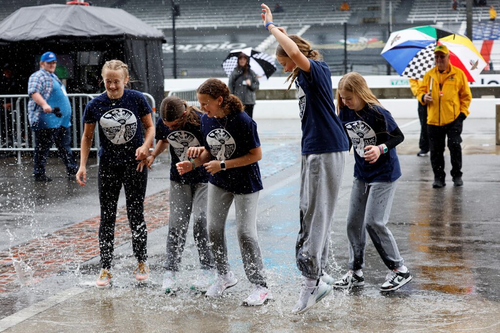 Fans Singing in the Rain - Indianapolis 500 Practice - By: Paul Hurley