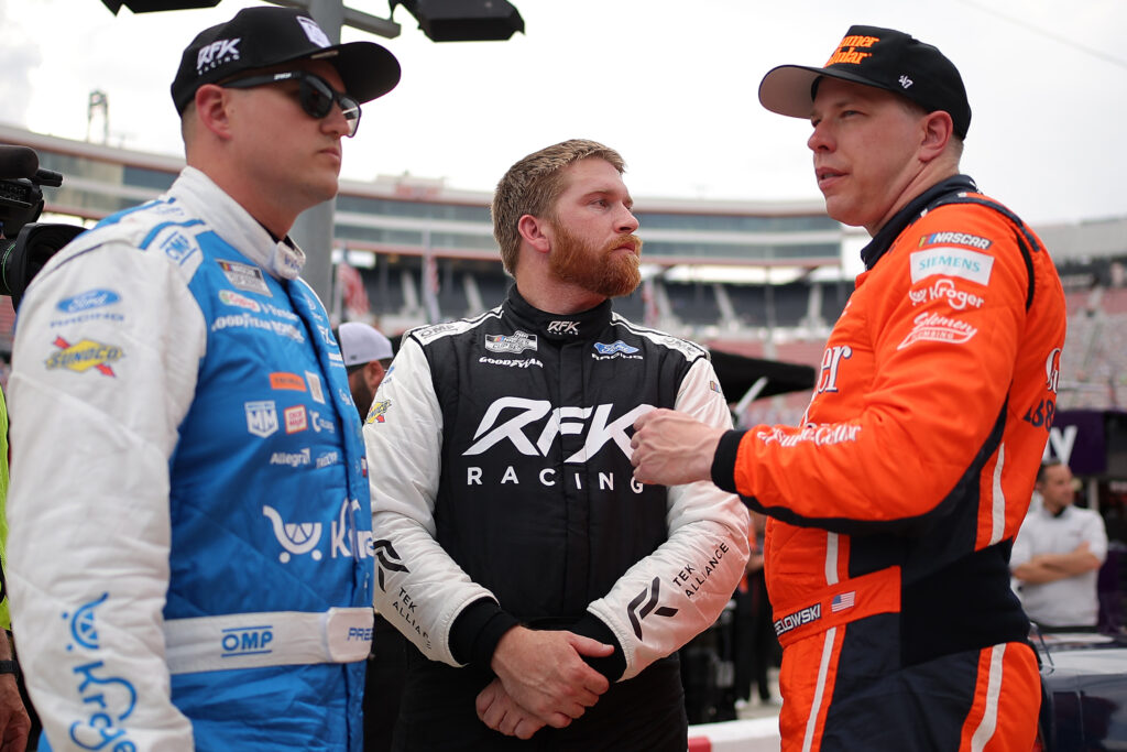Ryan Preece, Chris Buescher and Brad Keselowski talk on the grid during qualifying for the NASCAR Cup Series Food City 500 at Bristol Motor Speedway on April 11, 2026 in Bristol, Tennessee. (Photo by Jonathan Bachman/Getty Images)