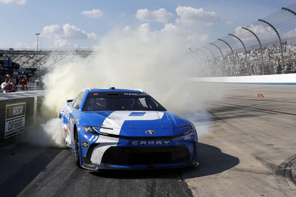 DOVER, DELAWARE - MAY 17: Denny Hamlin, driver of the #11 Progressive Insurance Toyota, celebrates with a burnout after winning the NASCAR Cup Series All-Star Race at Dover Motor Speedway on May 17, 2026 in Dover, Delaware. (Photo by Sean Gardner/Getty Images)