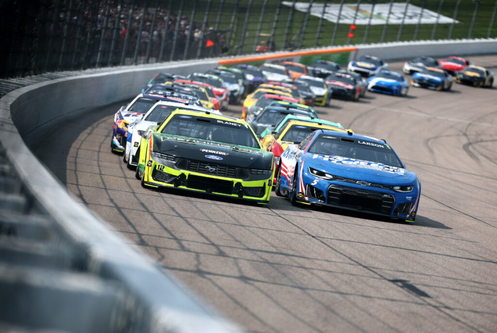 NEWTON, IOWA - AUGUST 09: Ryan Blaney, driver of the #12 Menards/Pennington Ford, and Kyle Larson, driver of the #5 HendrickCars.com Chevrolet, race during the NASCAR Cup Series Iowa Corn 350 Powered by Ethanol at Iowa Speedway on August 09, 2026 in Newton, Iowa. (Photo by Chris Graythen/Getty Images)