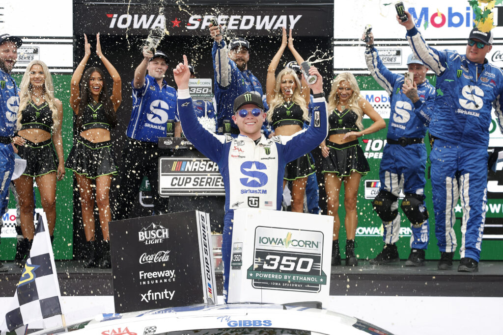 NEWTON, IOWA - AUGUST 09: Ty Gibbs, driver of the #54 SiriusXM Toyota, celebrates in victory lane after winning the NASCAR Cup Series Iowa Corn 350 Powered by Ethanol at Iowa Speedway on August 09, 2026 in Newton, Iowa. (Photo by Sean Gardner/Getty Images)