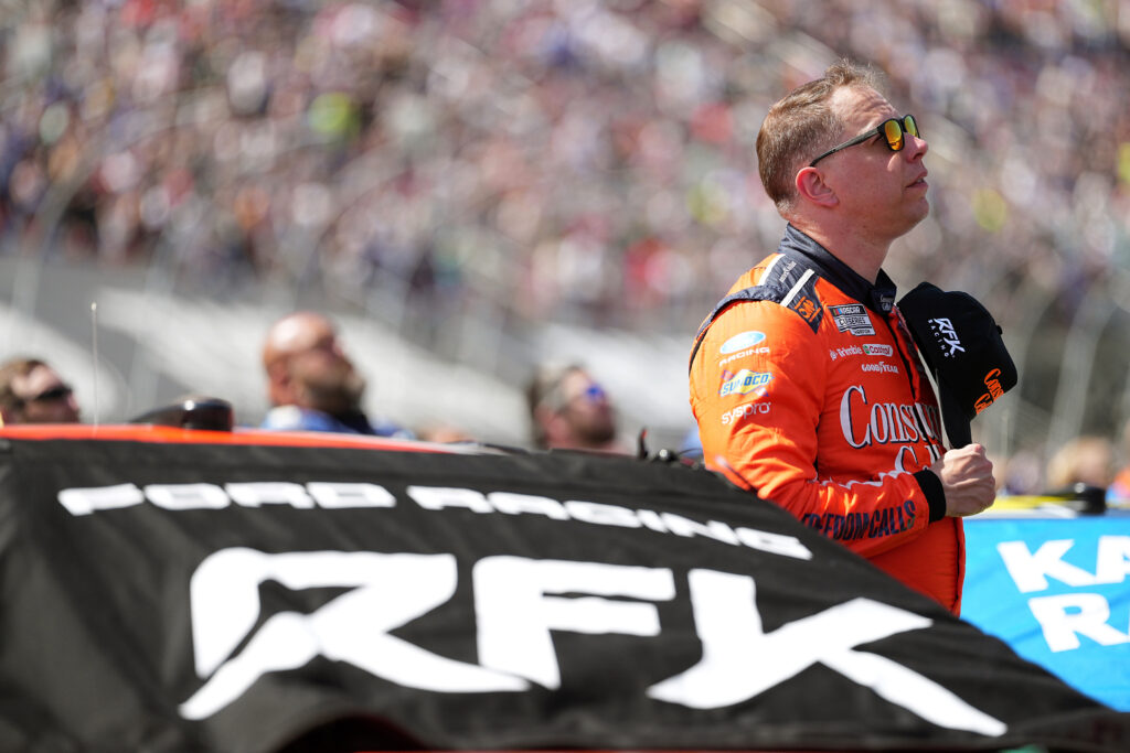 Brad Keselowski, driver of the #6 Consumer Cellular Ford, stands during the national anthem prior to the NASCAR Cup Series Food City 500 at Bristol Motor Speedway on April 12, 2026 in Bristol, Tennessee. (Photo by Matt Kelley/Getty Images)