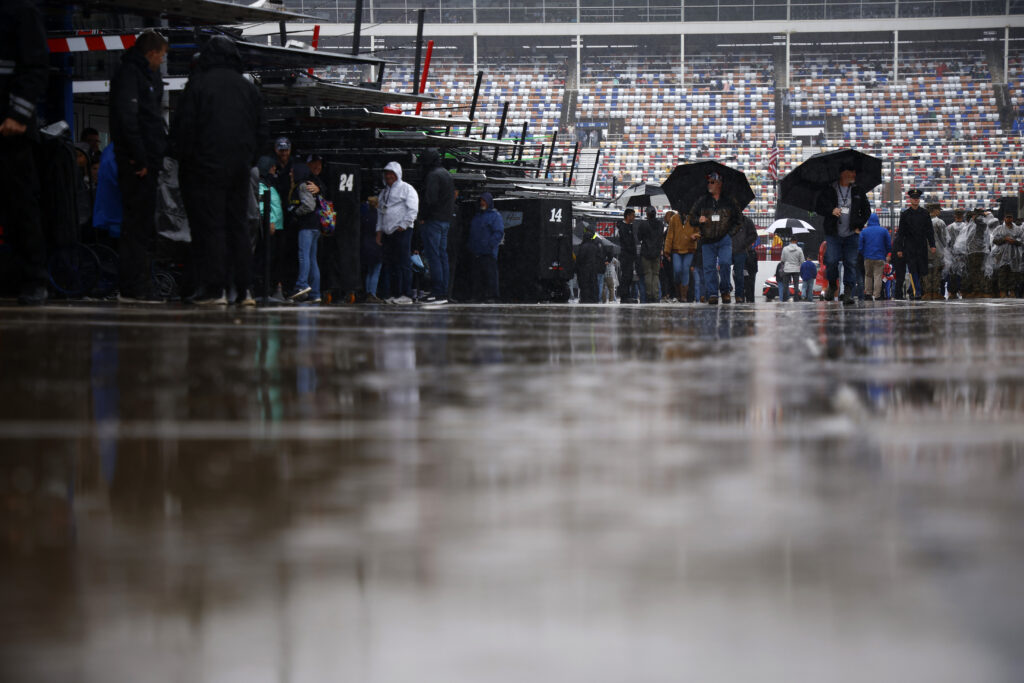 CONCORD, NORTH CAROLINA - MAY 28: Fans walk through the garage area as it rains prior to the NASCAR Cup Series Coca-Cola 600 at Charlotte Motor Speedway on May 28, 2023 in Concord, North Carolina. (Photo by Jared C. Tilton/Getty Images)