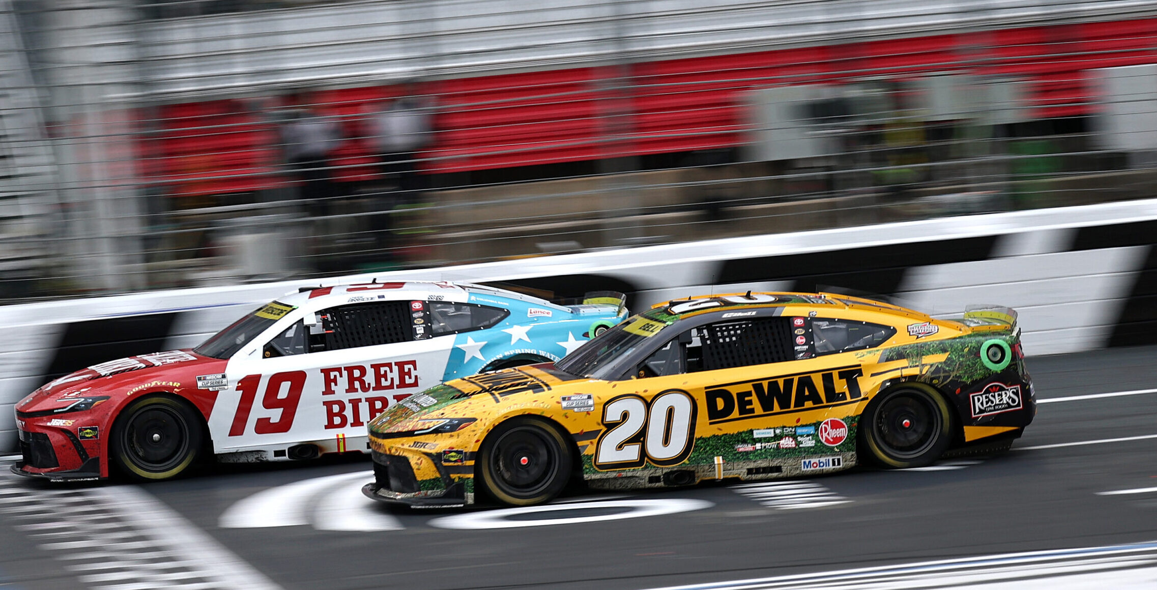 CONCORD, NORTH CAROLINA - OCTOBER 11: Chase Briscoe, driver of the #19 Freebird Spring Water Toyota, crosses the finish line ahead of Christopher Bell, driver of the #20 DeWalt Toyota, to win the NASCAR Cup Series Bank of America 400 at Charlotte Motor Speedway on October 11, 2026 in Concord, North Carolina. (Photo by Jared C. Tilton/Getty Images)